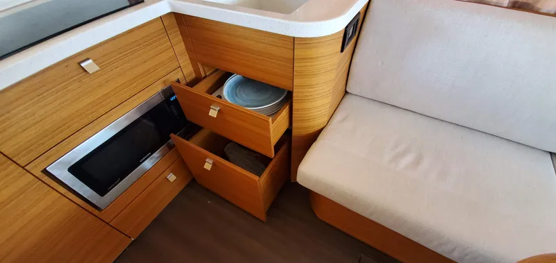 Slide: The Image of Modern kitchen area in 2023 Greenline 40 yacht with wooden cabinets and microwave. - 36