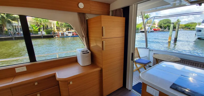 Slide: The Image of Interior of 2023 Greenline 40 yacht with modern wood finish and waterfront view. - 37