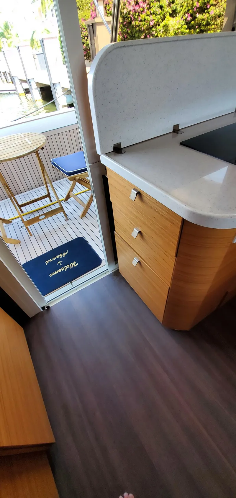 Slide: The Image of Interior of 2023 Greenline 40 yacht with wooden cabinetry and outdoor seating area. - 39