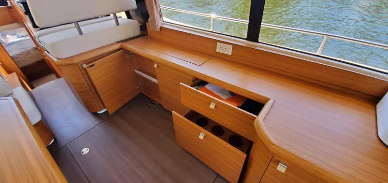 Slide: The Image of Interior of 2023 Greenline 40 yacht with wooden cabinetry and open drawers. - 42