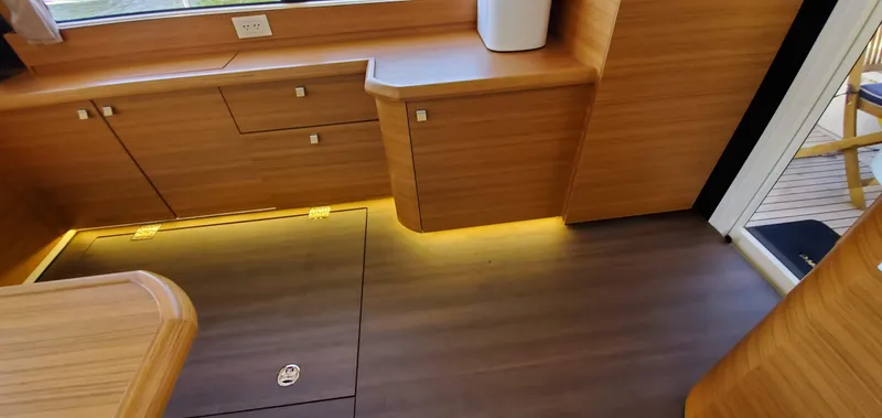 Slide: The Image of Modern interior of 2023 Greenline 40 yacht with wooden cabinetry and ambient lighting. - 46