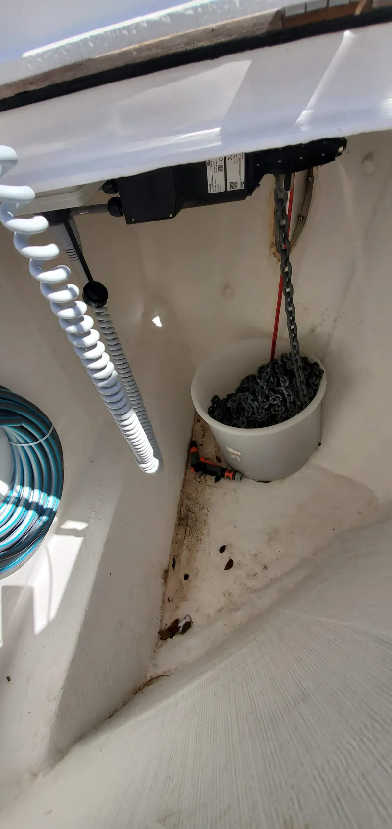 Slide: The Image of Interior of 2023 Greenline 40 boat showing anchor chain storage and coiled hose. - 9