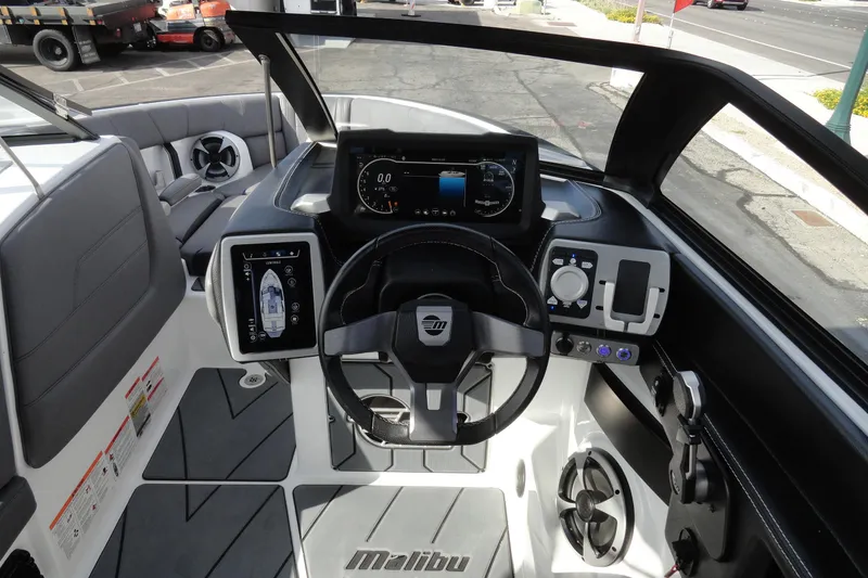 Slide: The Image of 2021 Malibu Wakesetter 23 LSV boat dashboard with modern controls and steering wheel. - 10