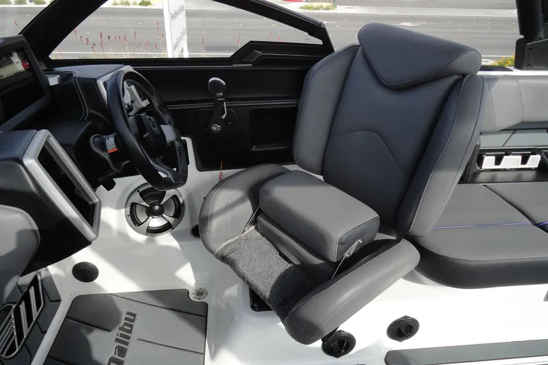 Slide: The Image of 2021 Malibu Wakesetter 23 LSV interior with sleek black seating and modern dashboard design. - 14