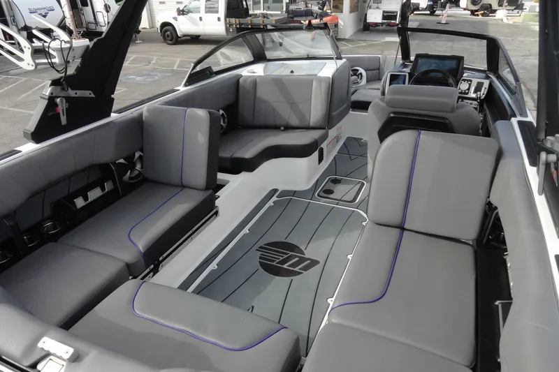 Slide: The Image of 2021 Malibu Wakesetter 23 LSV interior with gray seating and modern dashboard. - 16