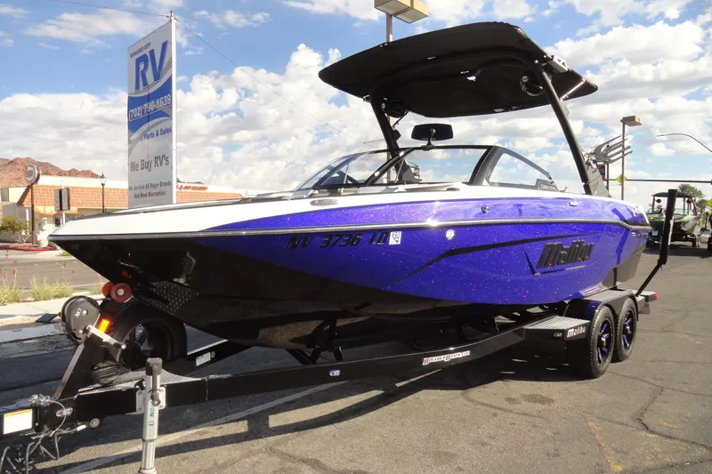 Slide: The Image of 2021 Malibu Wakesetter 23 LSV boat on trailer, parked at RV dealership. - 2