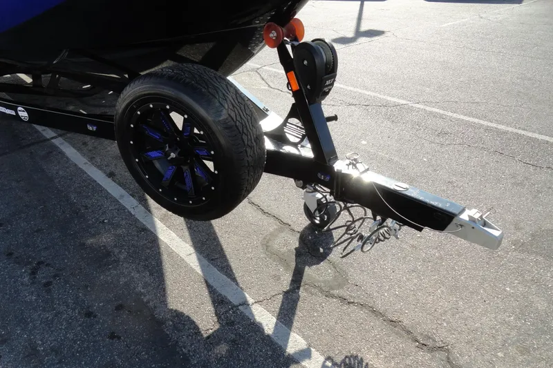 Slide: The Image of Trailer hitch and wheel of 2021 Malibu Wakesetter 23 LSV in parking lot. - 27