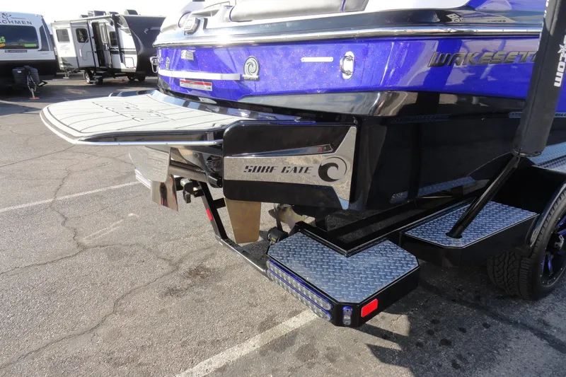 Slide: The Image of 2021 Malibu Wakesetter 23 LSV boat with Surf Gate feature, parked on a trailer. - 7