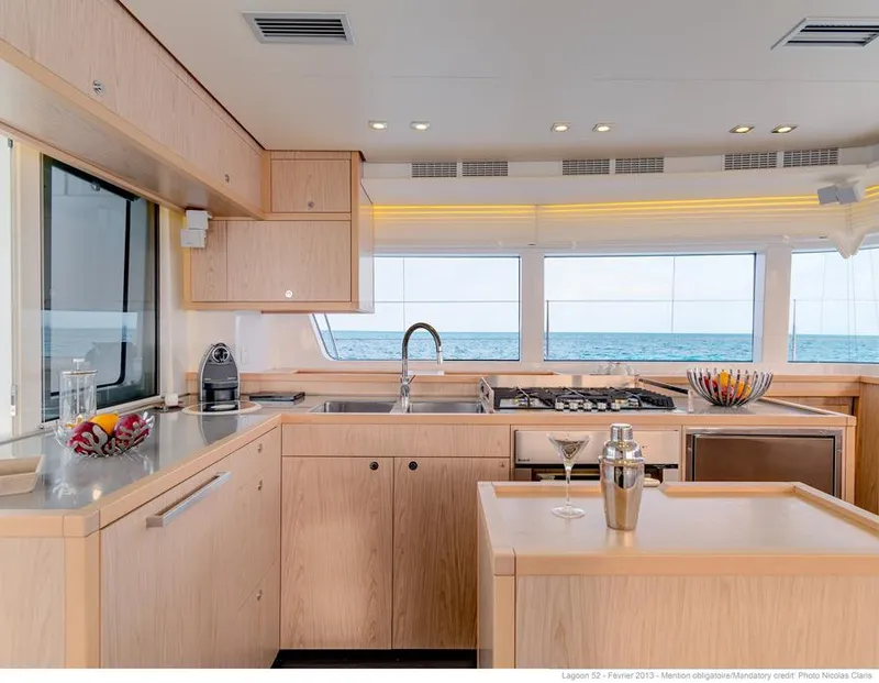 Slide: The Image of 2017 Lagoon 52 F catamaran docked, showcasing deck and rigging details. - 11