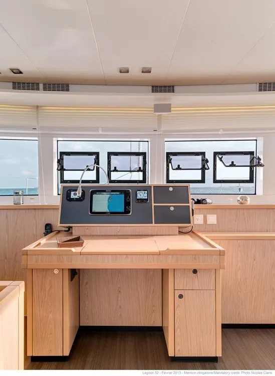Slide: The Image of Spacious cockpit of 2017 Lagoon 52 F catamaran with seating and helm station. - 12