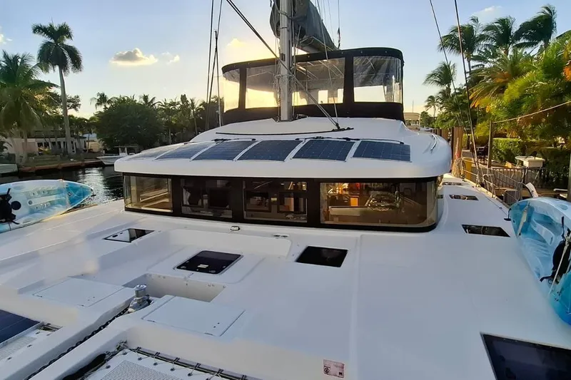 Slide: The Image of 2017 Lagoon 52 F catamaran with solar panels and cushioned seating on deck. - 2