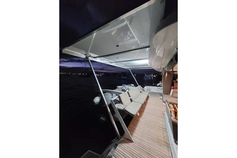 Slide: The Image of Aerial view of 2017 Lagoon 52 F catamaran with solar panels on green water. - 7