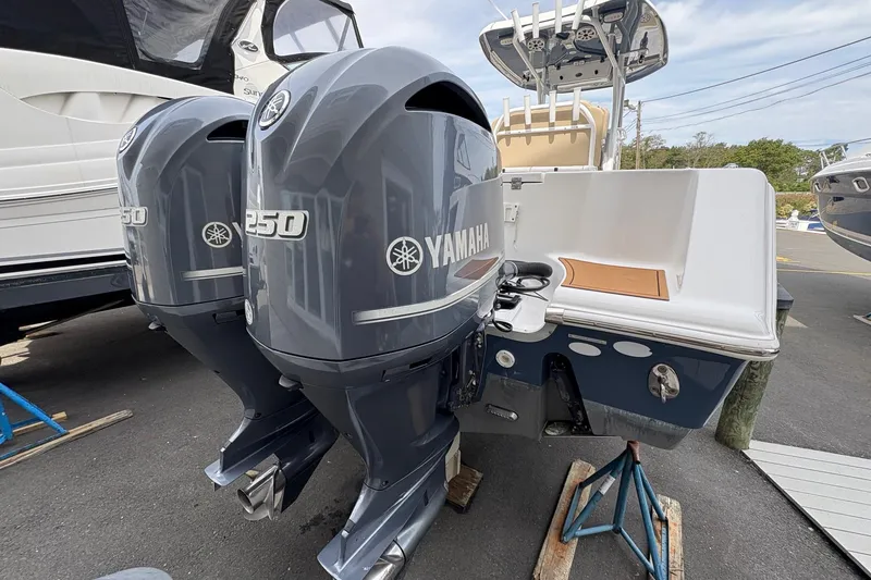 Slide: The Image of 2018 Tidewater 280 CC Adventure boat with Yamaha outboard motor, docked outdoors. - 12