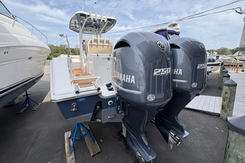 Slide: The Image of 2018 Tidewater 280 CC Adventure with dual Yamaha 250 engines, docked outdoors. - 13