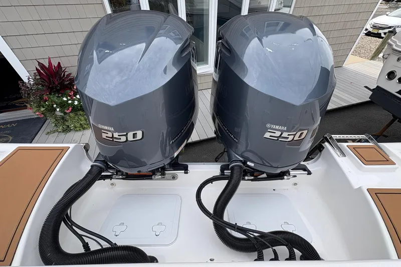 Slide: The Image of 2018 Tidewater 280 CC Adventure boat with dual Yamaha 250 engines, docked outdoors. - 14