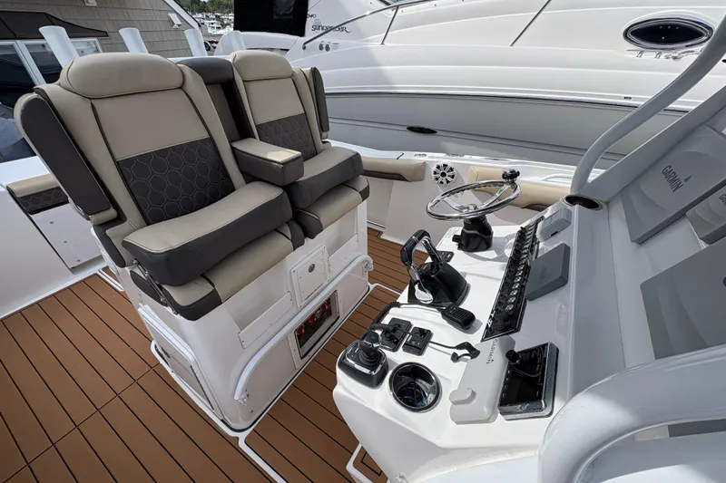 Slide: The Image of 2018 Tidewater 280 CC Adventure boat with cushioned seating and dual outboard motors. - 19