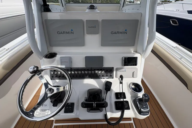 Slide: The Image of 2018 Tidewater 280 CC Adventure boat cockpit with dual seats and modern controls. - 20