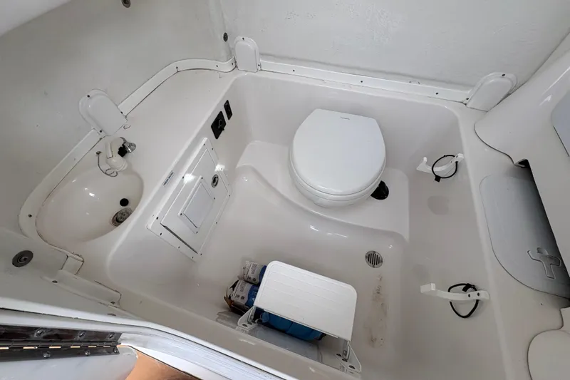 Slide: The Image of 2018 Tidewater 280 CC Adventure boat interior bathroom with toilet and porthole. - 26