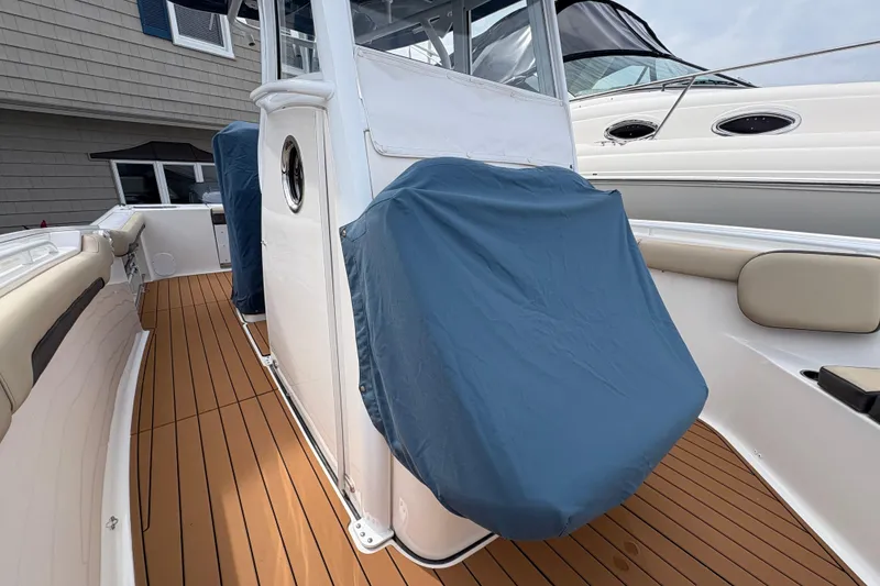 Slide: The Image of 2018 Tidewater 280 CC Adventure boat with covered seats on teak deck. - 28