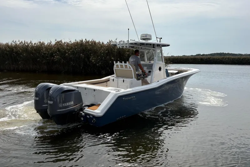 Slide: The Image of 2018 Tidewater 280 CC Adventure boat cruising on a calm river. - 3
