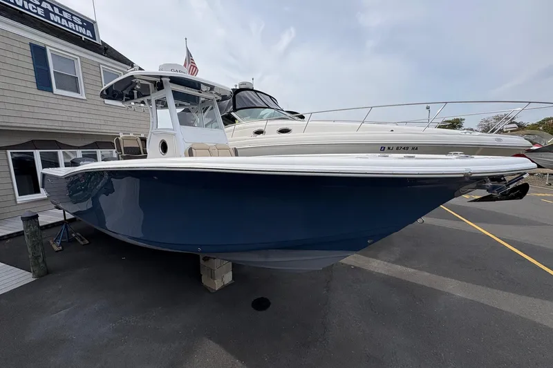 Slide: The Image of 2018 Tidewater 280 CC Adventure boat with dual Yamaha engines on a calm river. - 5