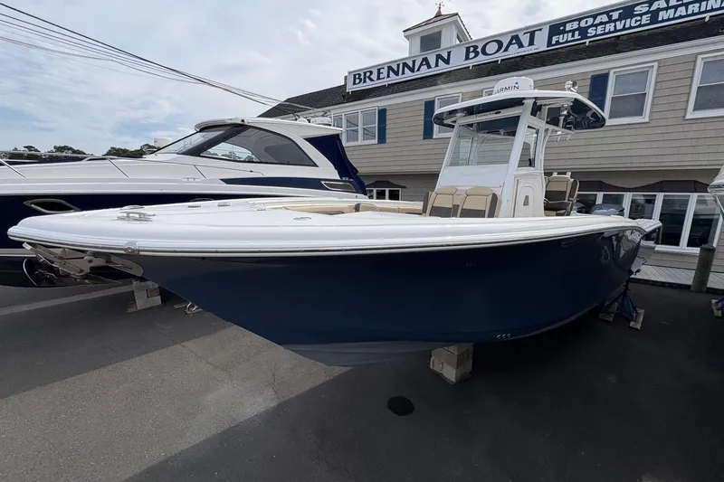 Slide: The Image of 2018 Tidewater 280 CC Adventure boat with Yamaha engine, docked outdoors. - 6