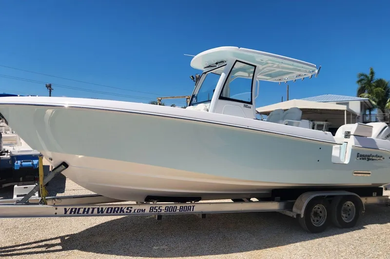 The Image of 2026 Everglades 285 Center Console boat on trailer under clear blue sky. - 0