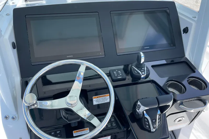 Slide: The Image of 2026 Everglades 285 Center Console dashboard with dual Garmin displays and steering wheel. - 11
