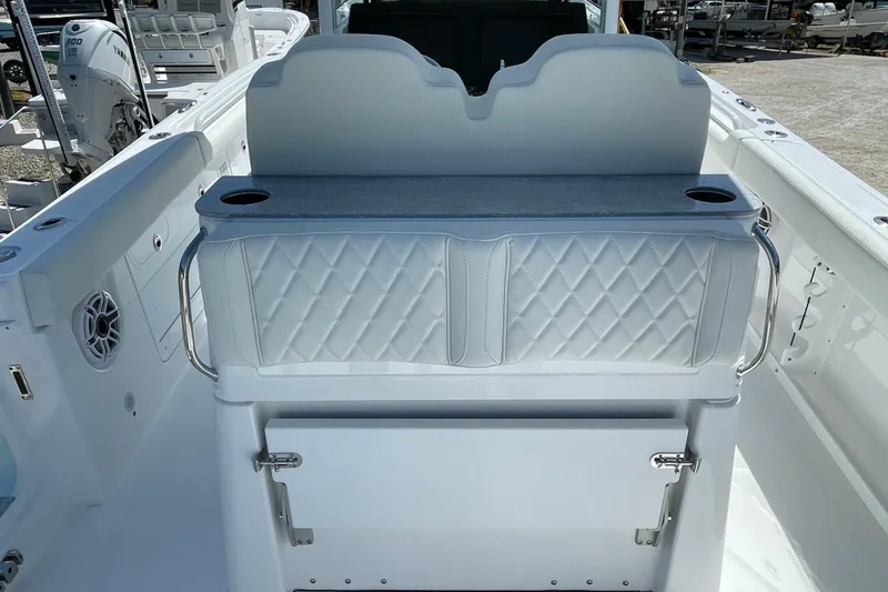 Slide: The Image of 2026 Everglades 285 Center Console boat interior with cushioned seating and storage. - 13