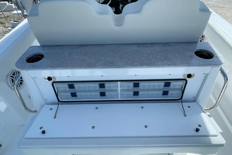 Slide: The Image of 2026 Everglades 285 Center Console boat interior with storage and cup holders. - 14