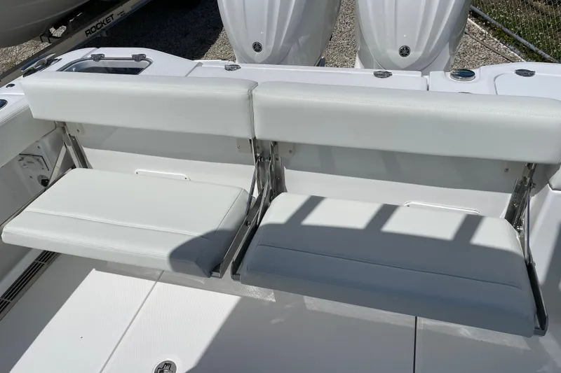 Slide: The Image of 2026 Everglades 285 Center Console boat with white cushioned seating and dual engines. - 17