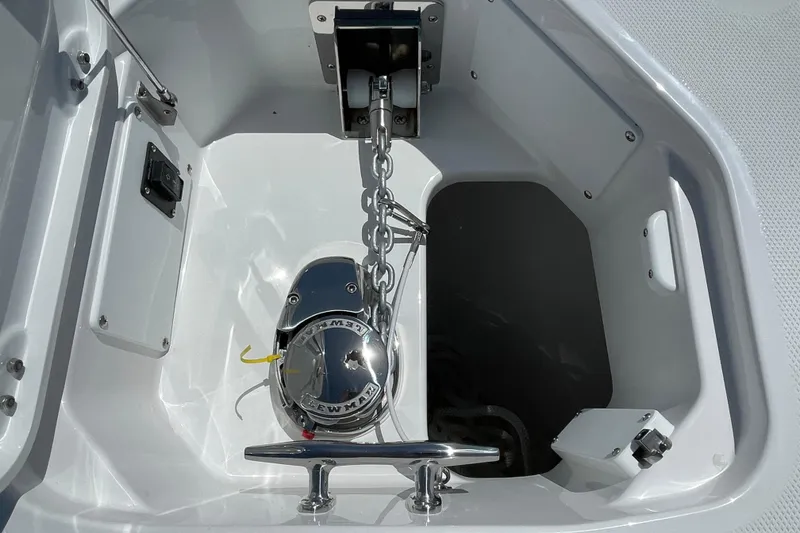 Slide: The Image of Anchor compartment of 2026 Everglades 285 Center Console boat, featuring a polished windlass. - 2