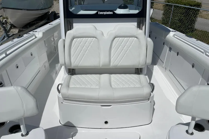 Slide: The Image of 2026 Everglades 285 Center Console boat with white cushioned seating and sleek design. - 5