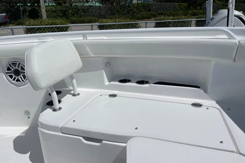 Slide: The Image of 2026 Everglades 285 Center Console boat interior with white seating and speaker. - 7
