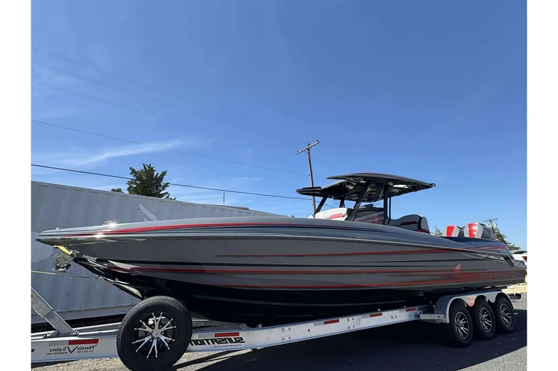 The Image of 2026 Sunsation 32 CCX boat on trailer under clear blue sky. - 1