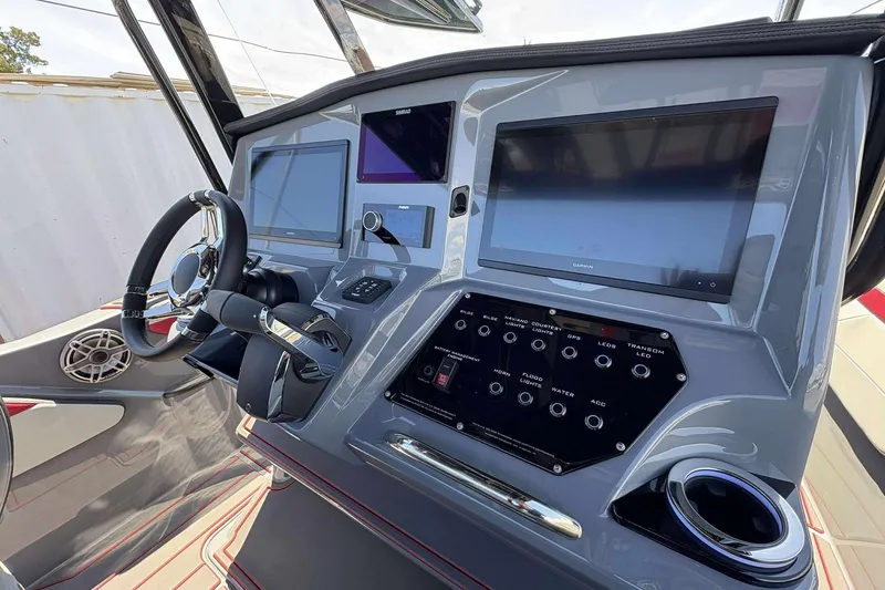 Slide: The Image of 2026 Sunsation 32 CCX boat dashboard with advanced navigation screens and controls. - 15