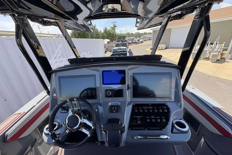 Slide: The Image of 2026 Sunsation 32 CCX boat dashboard with dual screens and modern controls. - 27