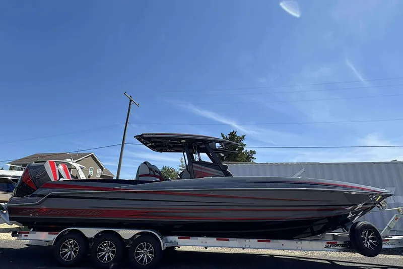 Slide: The Image of 2026 Sunsation 32 CCX boat on trailer under clear blue sky. - 3