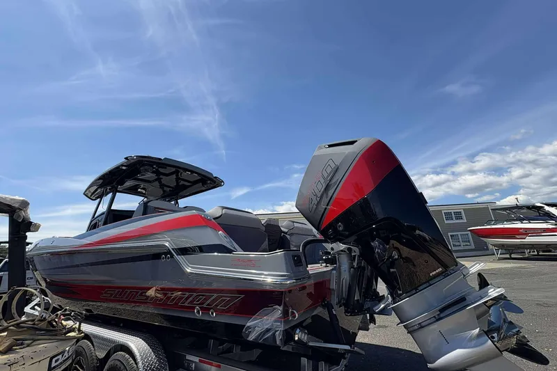 Slide: The Image of 2026 Sunsation 32 CCX boat with powerful outboard motor under clear blue sky. - 4