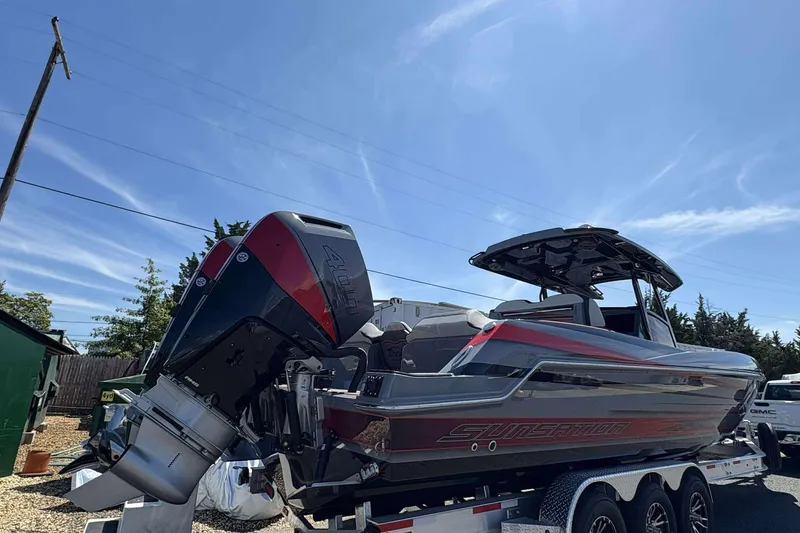 Slide: The Image of 2026 Sunsation 32 CCX boat on trailer under clear blue sky. - 5