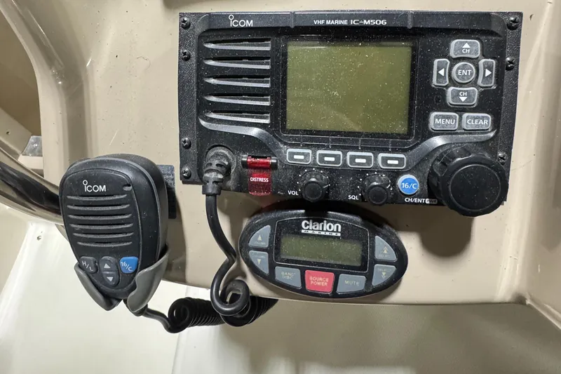 Slide: The Image of Control panel of a 2004 Sea Ray 320 Sundancer with Icom VHF radio and Clarion audio system. - 36