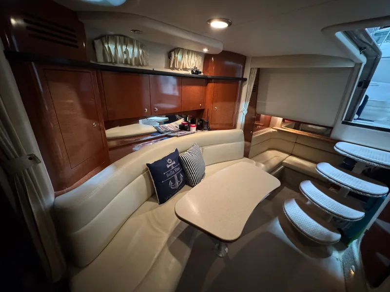 Slide: The Image of Interior of 2004 Sea Ray 320 Sundancer with cozy seating and elegant wood cabinetry. - 38
