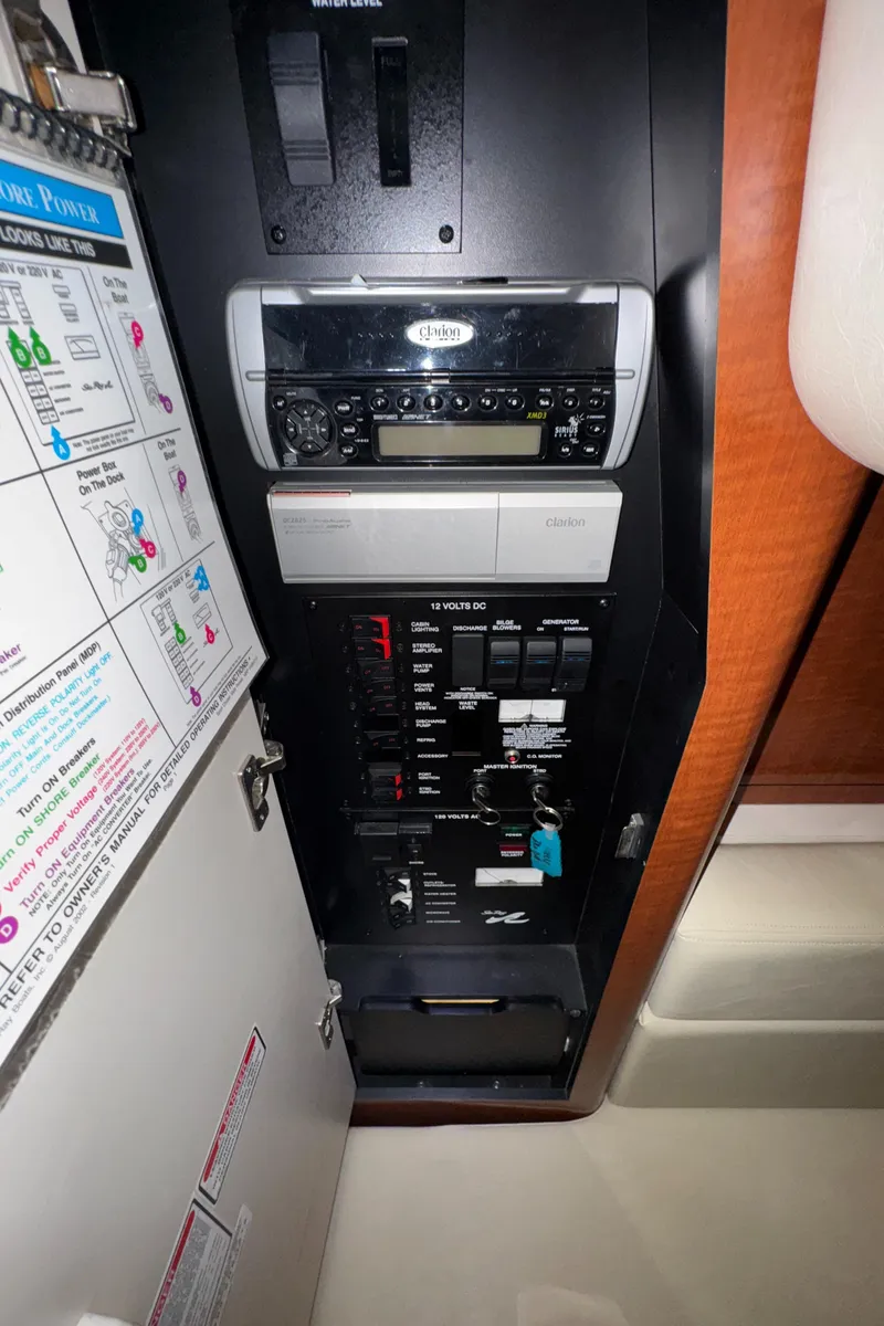 Slide: The Image of Control panel of 2004 Sea Ray 320 Sundancer boat with stereo system and circuit breakers. - 47