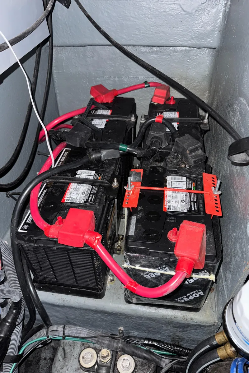 Slide: The Image of Batteries in a 2004 Sea Ray 320 Sundancer boat, connected with red cables. - 53