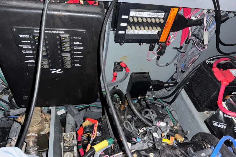 Slide: The Image of Electrical components and wiring inside a 2004 Sea Ray 320 Sundancer boat. - 54