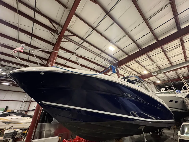 Slide: The Image of 2004 Sea Ray 320 Sundancer boat in indoor storage facility. - 55