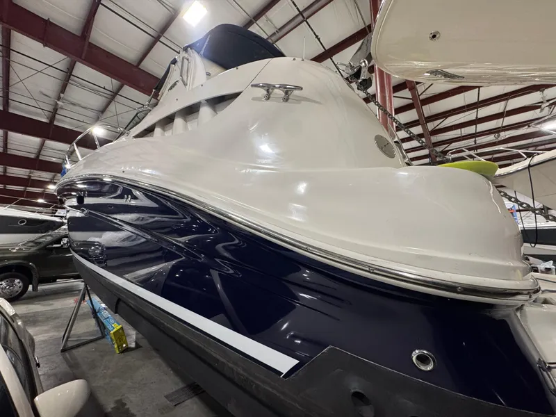 Slide: The Image of 2004 Sea Ray 320 Sundancer boat in indoor storage facility. - 56