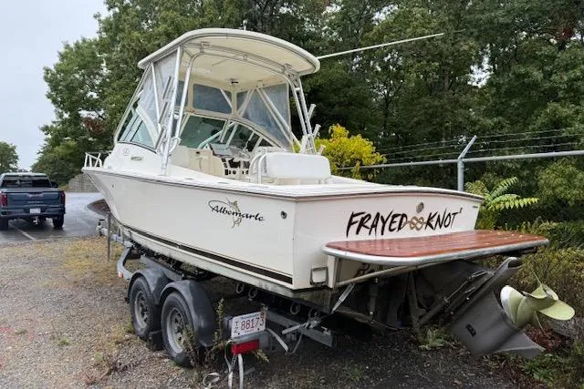 Slide: The Image of 2005 Albemarle 248 Express Fisherman boat on trailer, named "Frayed Knot," parked outdoors. - 1