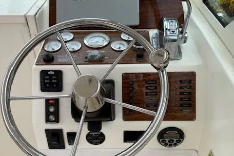 Slide: The Image of 2005 Albemarle 248 Express Fisherman helm with steering wheel and control panel. - 10
