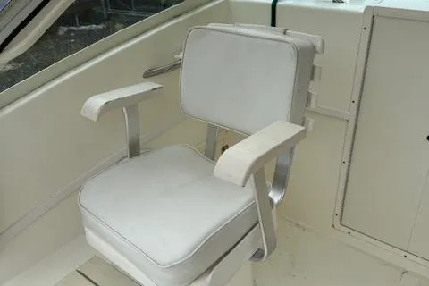 Slide: The Image of 2005 Albemarle 248 Express Fisherman boat seat with white upholstery and armrests. - 14